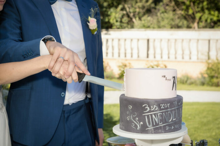 Hochzeitsfotograf Potsdam macht natürliche Hochzeitsbilder - Brautpaar beim Anschnitt der Hochzeitstorte bei der Hochzeitsfeier im Landhaus Adlon Potsdam am Lehnitzsee